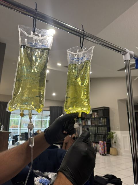 Two drips being set up with gloved hands